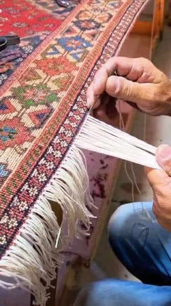 Reconstrução das franjas de um tapete em trabalho artesanal